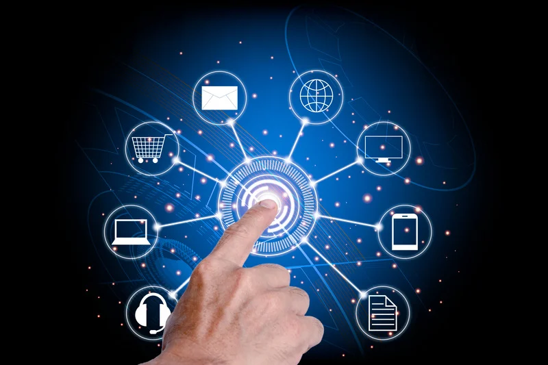A business professional working on a laptop with various icons of social media and professional networking sites hovering above, symbolizing a robust online presence.